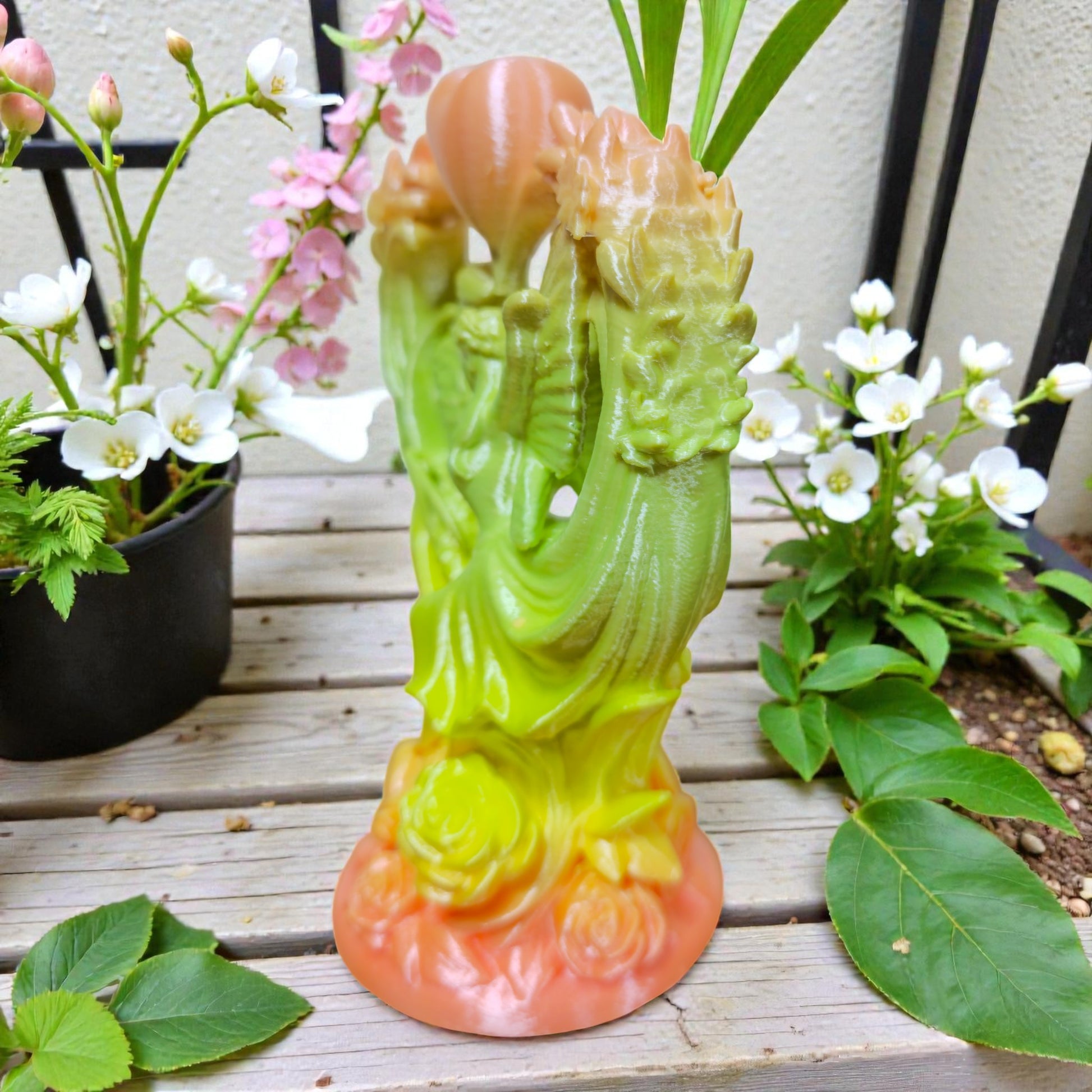 Back view of angel couple heart sculpture featuring detailed floral motifs and smooth gradient color transition in garden display